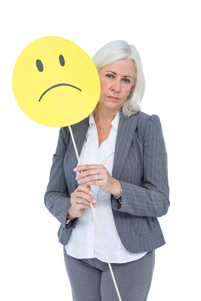 Affärskvinna anläggning ledsen smiley face — Stockfoto