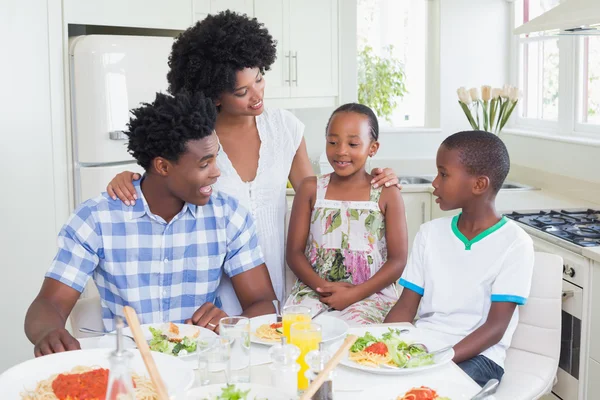 Glückliche Familie setzt sich zum gemeinsamen Abendessen zusammen — Stockfoto