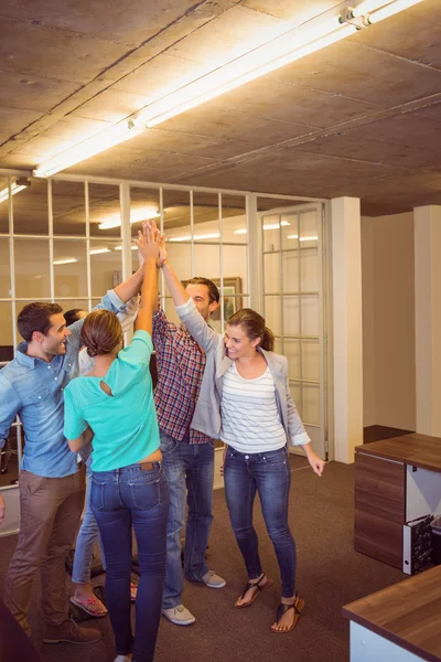 Creative business team raising their hands — Stock Photo, Image