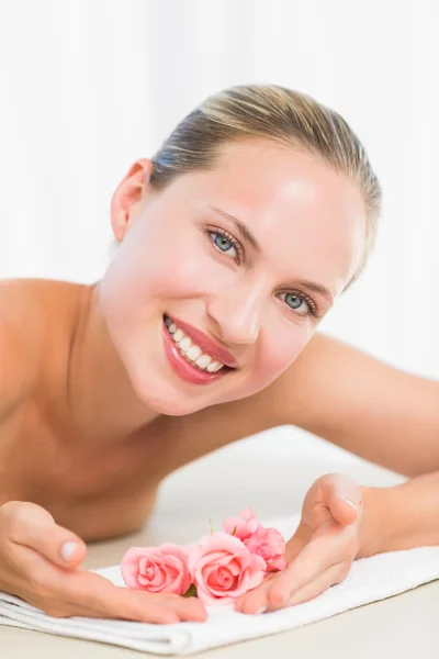 Peaceful blonde lying on towel smiling at camera — Stock Photo, Image