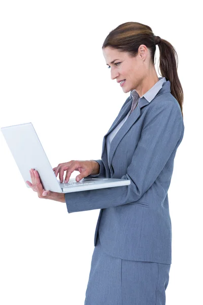 Confident businesswoman holding laptop Stock Photo