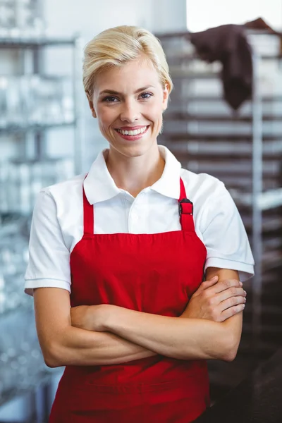 Pretty barista smiling at the camera Royalty Free Stock Images