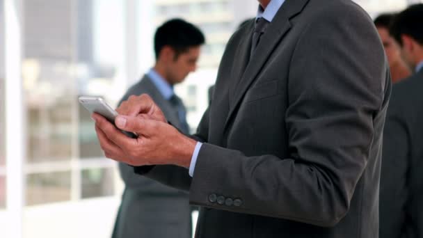 Businessman using smartphone with his colleagues — Stock Video