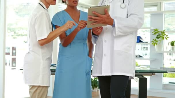 Medical team looking at clipboard — Stock Video