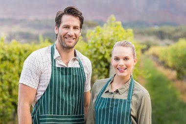 Two young happy vintners looking at camera clipart