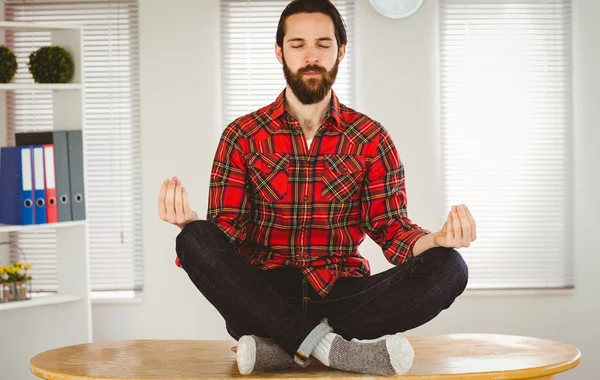 Hipster businessman meditating at his desk — Stok fotoğraf