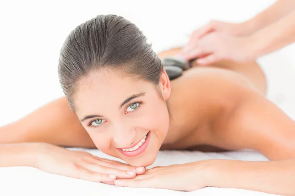 Brunette enjoying hot stone massage — Stock Photo, Image