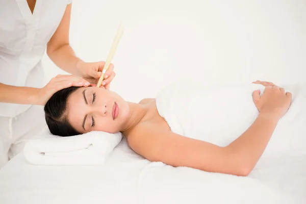 Woman receiving ear candle treatment — Stock Photo, Image