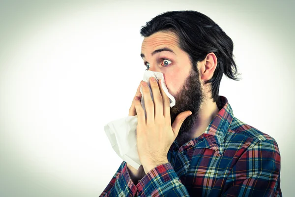 Handsome hipster blowing his nose — Stock Photo, Image