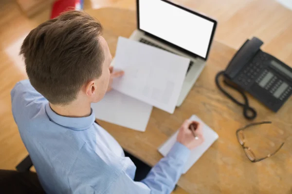 Focused businessman reading document at desk — Stock Photo, Image