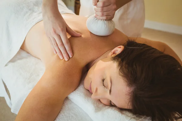 Woman getting herbal compress massage — Stock Photo, Image