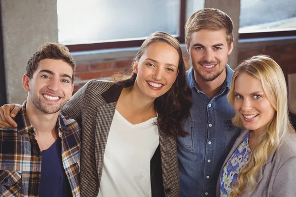 Smiling friends putting arms around each other — Stock Photo, Image