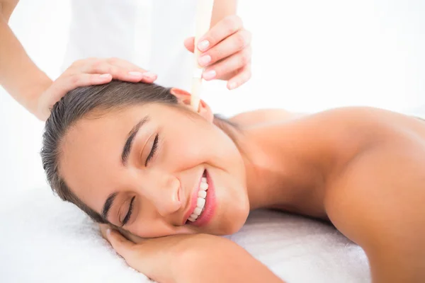 Woman receiving ear candle treatment — Stock Photo, Image