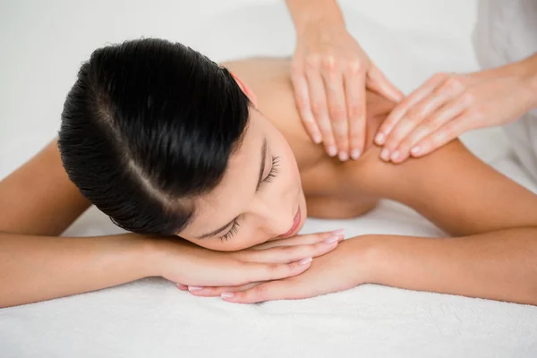 Brunette enjoying massage at spa — Stock Photo, Image