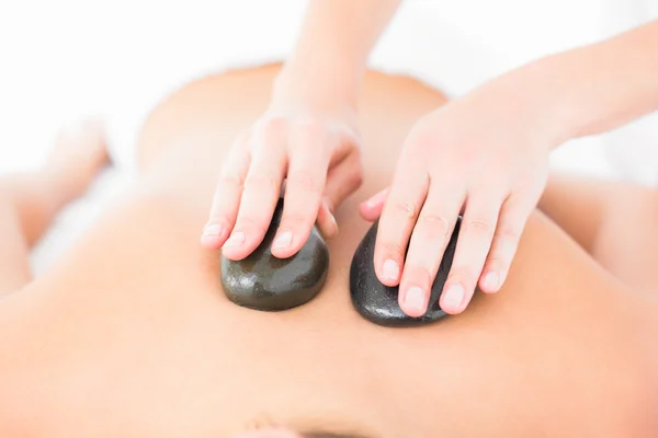 Woman enjoying hot stone massage — Stock Photo, Image