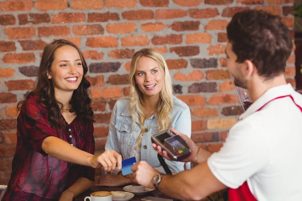 Pretty friends handing a credit card — Stock Photo, Image