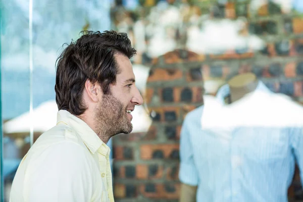 Sonriente hombre va ventana de compras — Foto de Stock