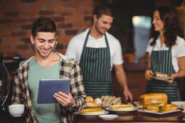 Smiling customer looking at tablet — Stock Photo, Image