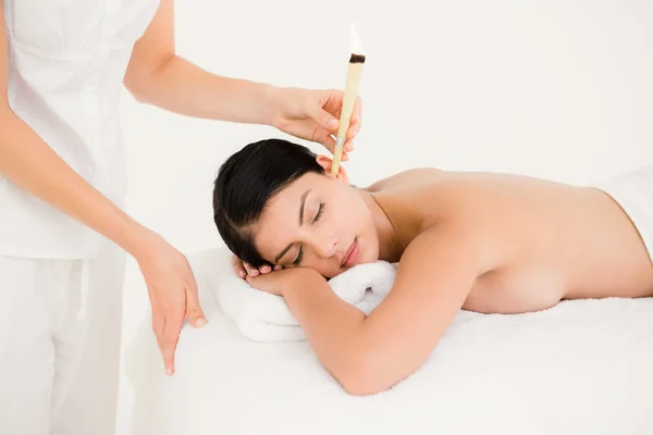 Woman receiving ear candle treatment — Stock Photo, Image