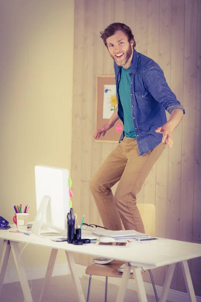 Hipster businessman standing on his chair — Stock Photo, Image