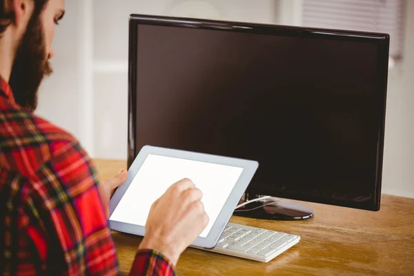 Hipster businessman working on his tablet pc — Stockfoto