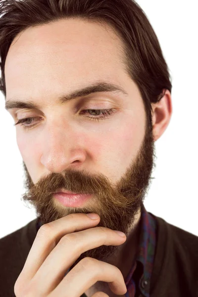 Hipster thinking with hand on chin — Stock Photo, Image