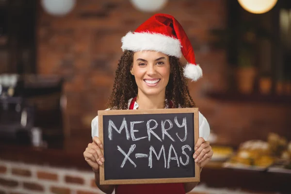 Pretty waitress with a chalkboard merry x-mas — Stock Photo, Image