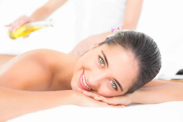 Brunette enjoying an oil massage — Stock Photo, Image