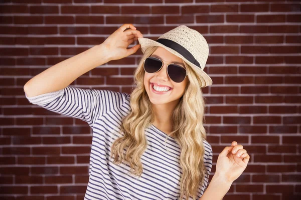 Gorgeous smiling blonde hipster posing with straw hat — Stock Photo, Image