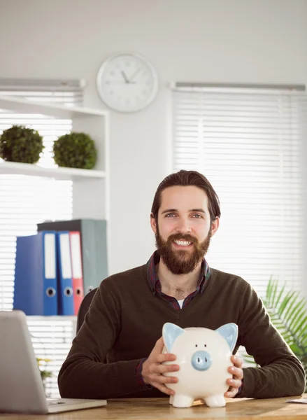 Hipster businessman with a piggy bank — Stock Photo, Image