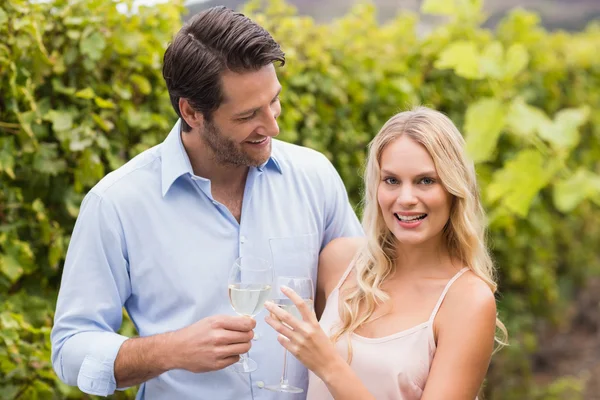 Couple smiling at camera and toasting — Stock Photo, Image