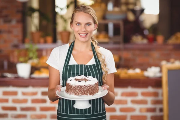 漂亮的女服务员拿着一个巧克力蛋糕 — 图库照片