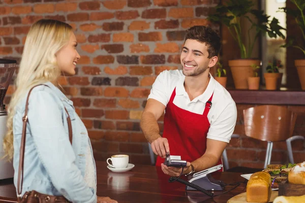 Smiling waiter using the pin terminal — Stock Photo, Image