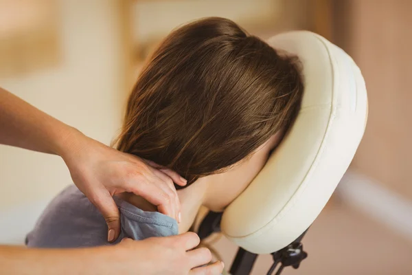 Woman getting massage in chair — Stock Photo, Image