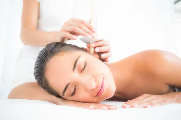 Woman receiving ear candle treatment — Stock Photo, Image