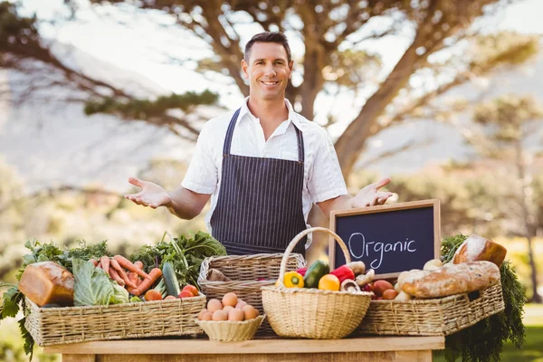 Smiling farmer presenting the local products — Stock Photo, Image