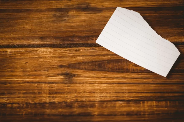 Scrap of paper on wooden table — Stock Photo, Image