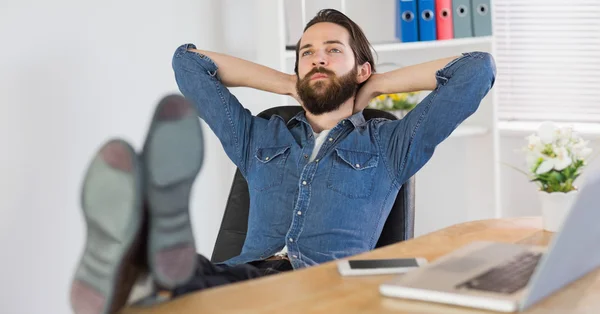 Hipster businessman relaxing at his desk — Stock Fotó