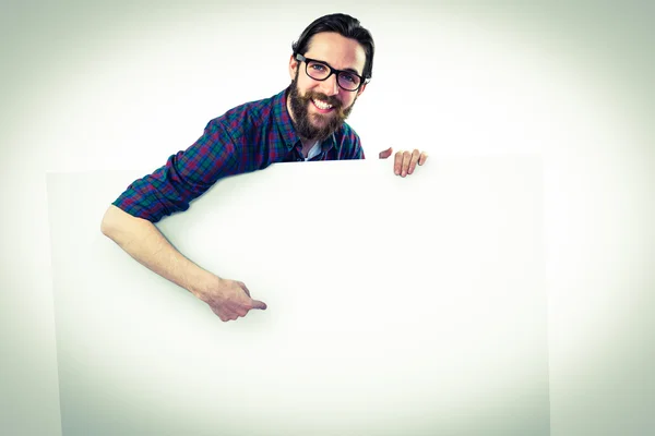 Handsome hipster showing large poster — Stock Photo, Image