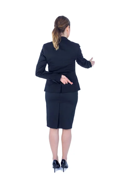 Pretty businesswoman with finger crossed — Stock Photo, Image