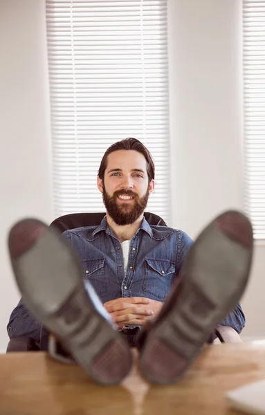Hipster businessman relaxing at his desk — Stock Photo, Image