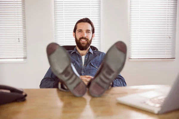 Hipster businessman relaxing at his desk — Stock Fotó