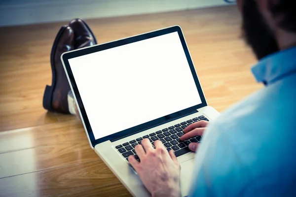 Handsome hipster using his laptop — Stock Photo, Image