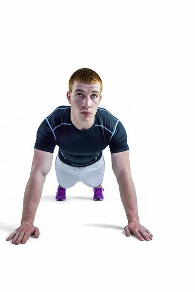 Muscular rugby player doing push ups — Stock Photo, Image