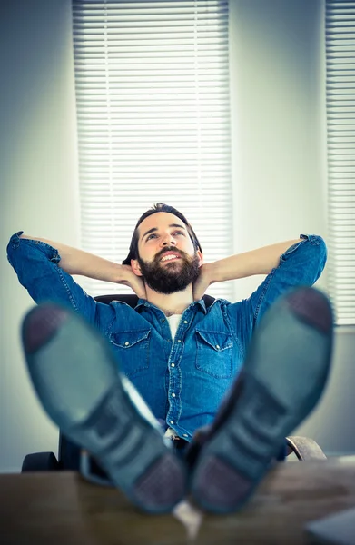 Hipster businessman relaxing at his desk — Stock Photo, Image