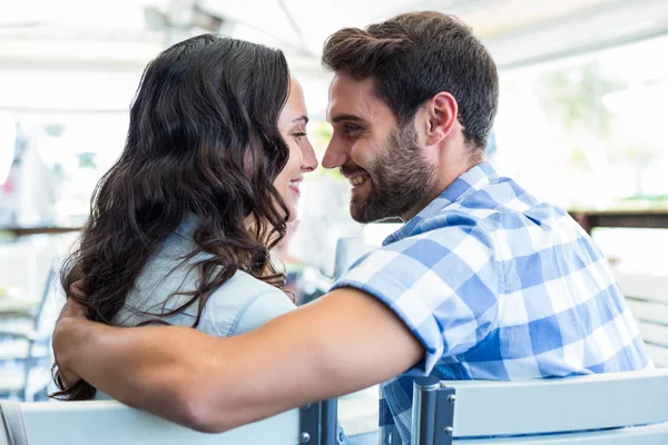 Cute couple sitting outside a cafe — Stock Photo, Image