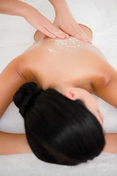 Woman enjoying a salt scrub massage — Stock Photo, Image