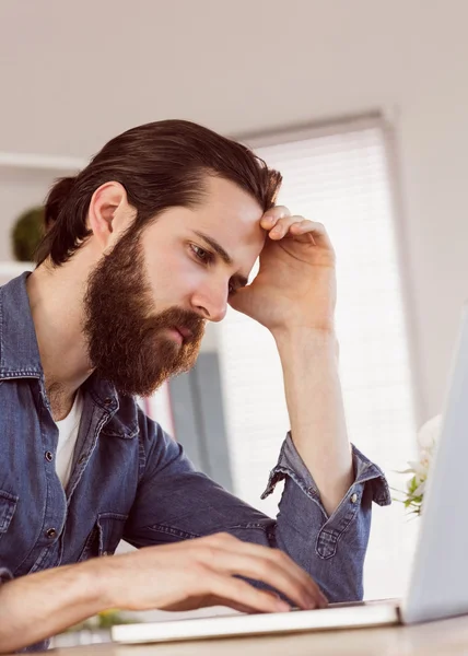 Hipster businessman looking at laptop — Stock Photo, Image