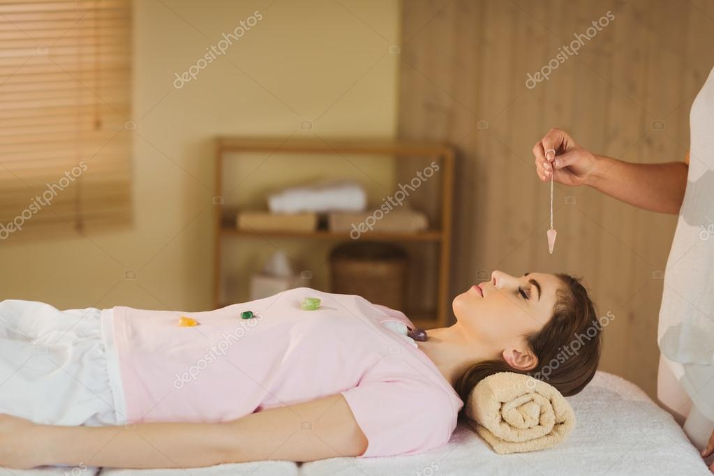 Young woman at crystal healing session — Stock Photo © Wavebreakmedia 81829300
