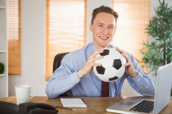 Empresário alegre segurando uma bola de futebol — Fotografia de Stock